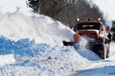 snowplow removing snow from intercity road from snow blizzard